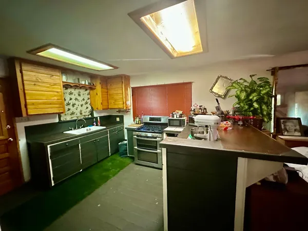 a kitchen with a sink cabinets and window