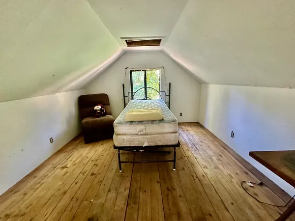 a bed room with a bed and a window