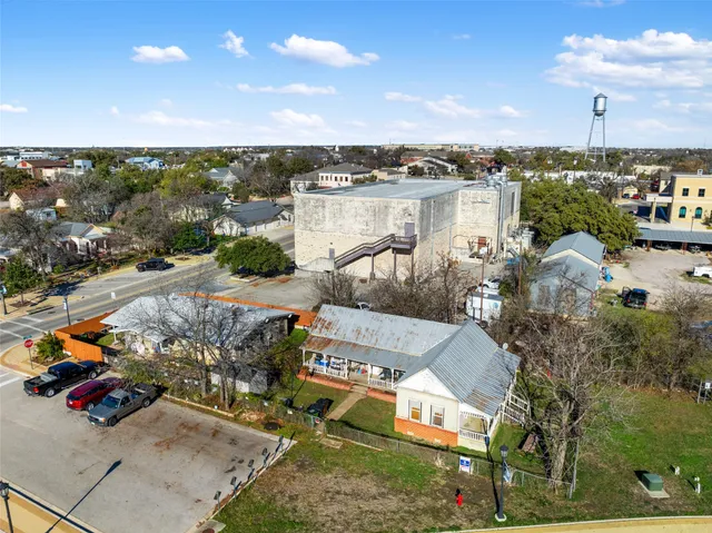 an aerial view of a house with a swimming pool and outdoor seating