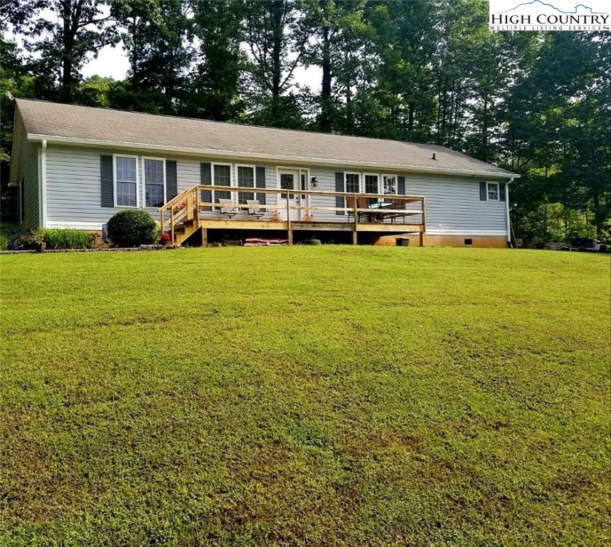 173 Country Road Deep Gap, NC 28618 - Photo 2 of 5 a view of a house with a backyard
