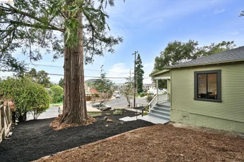 a view of a house with backyard porch and sitting area