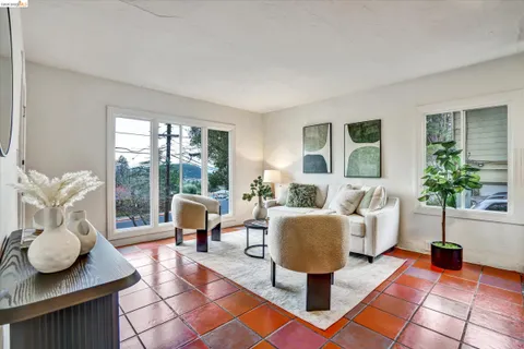 a living room with furniture and floor to ceiling windows