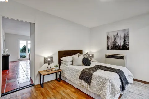 a bedroom with a bed and a view of painting