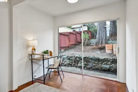 a room filed with furniture and a potted plant