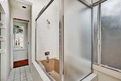 a bathroom with a tub shower and sink