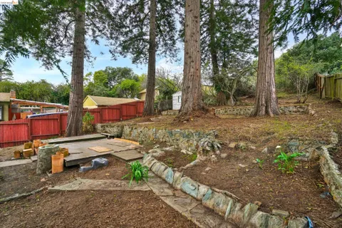 a view of a backyard with table and chairs under an umbrella