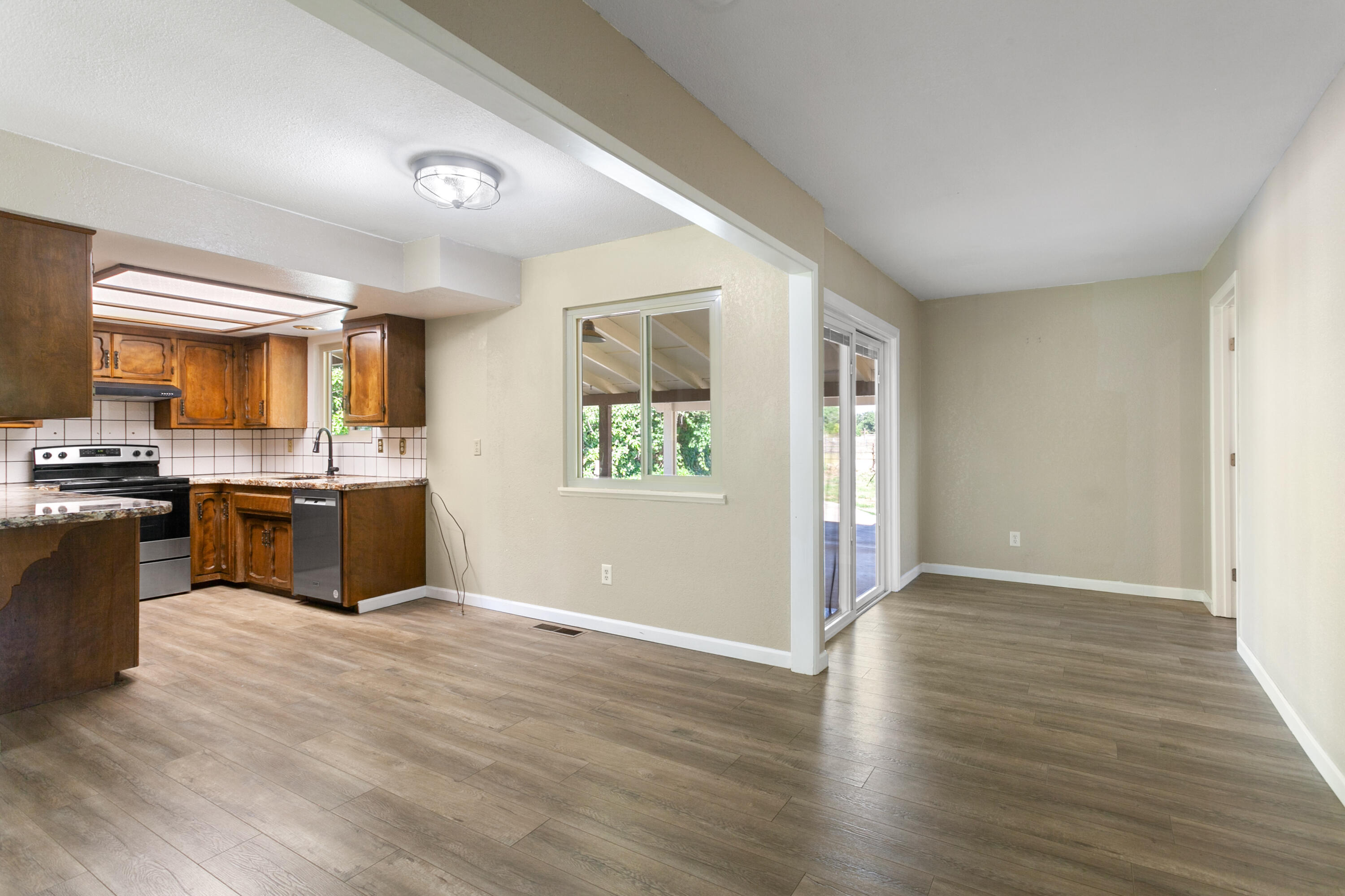 5858 Deschutes Road Anderson, CA 96007 - Photo 16 of 30 a kitchen with granite countertop wooden floors stainless steel appliances and a fireplace