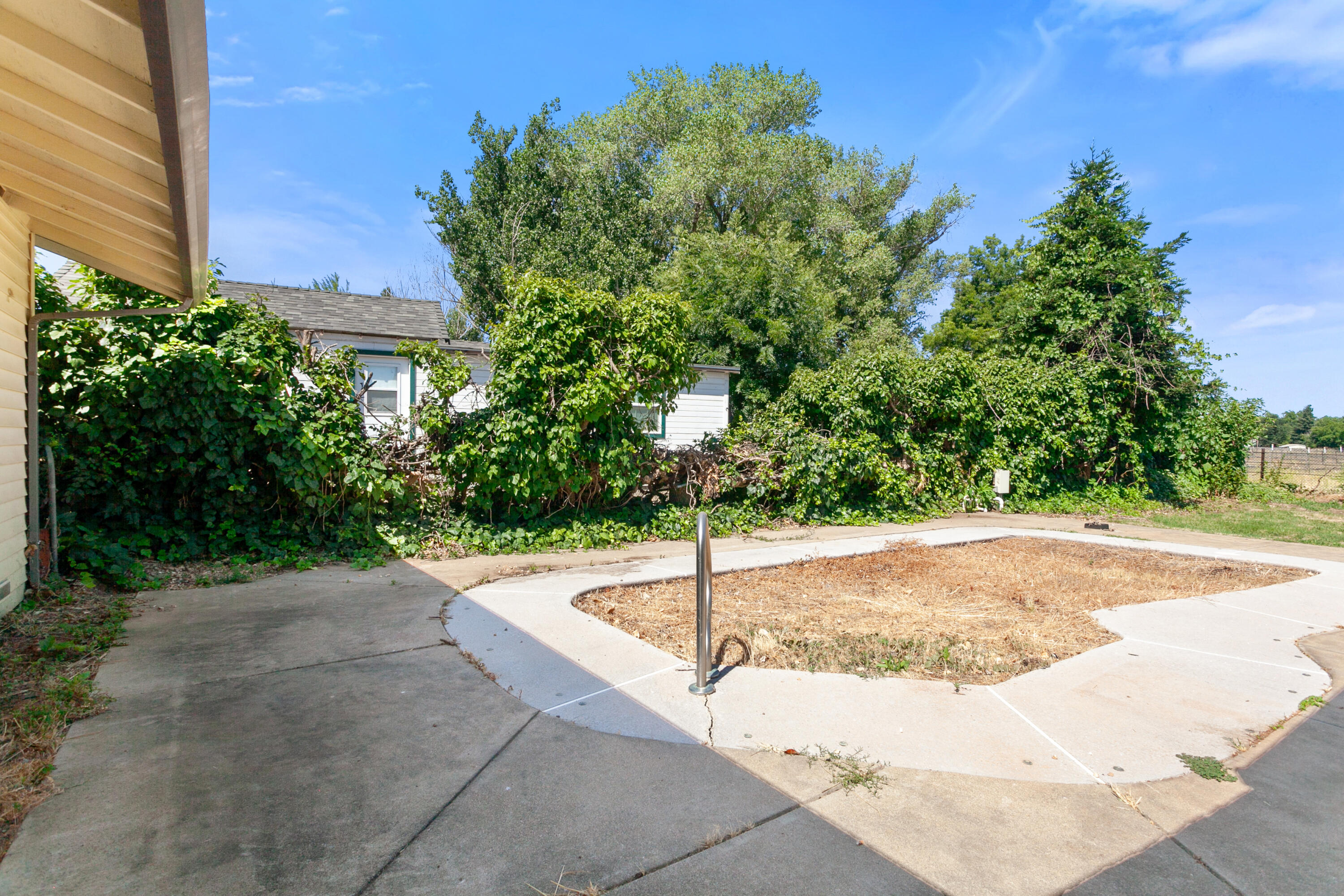 5858 Deschutes Road Anderson, CA 96007 - Photo 19 of 30 a white house with a yard and a street view