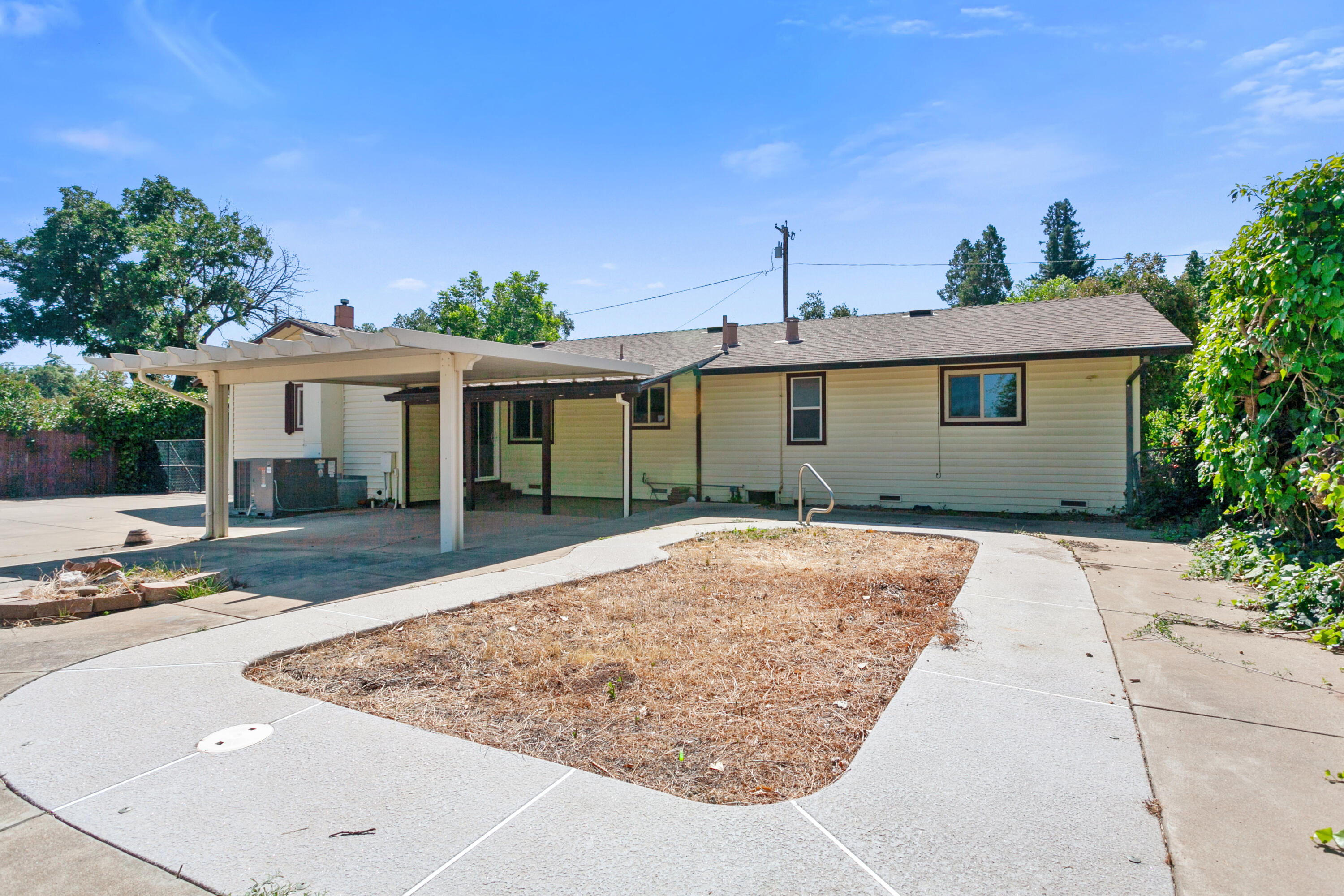 5858 Deschutes Road Anderson, CA 96007 - Photo 20 of 30 a view of a white house with a yard and potted plants