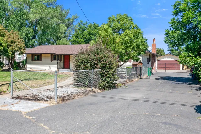 a view of a patio with a table and chairs under an umbrella