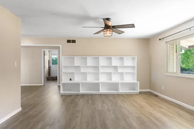 wooden floor in an empty room with a window
