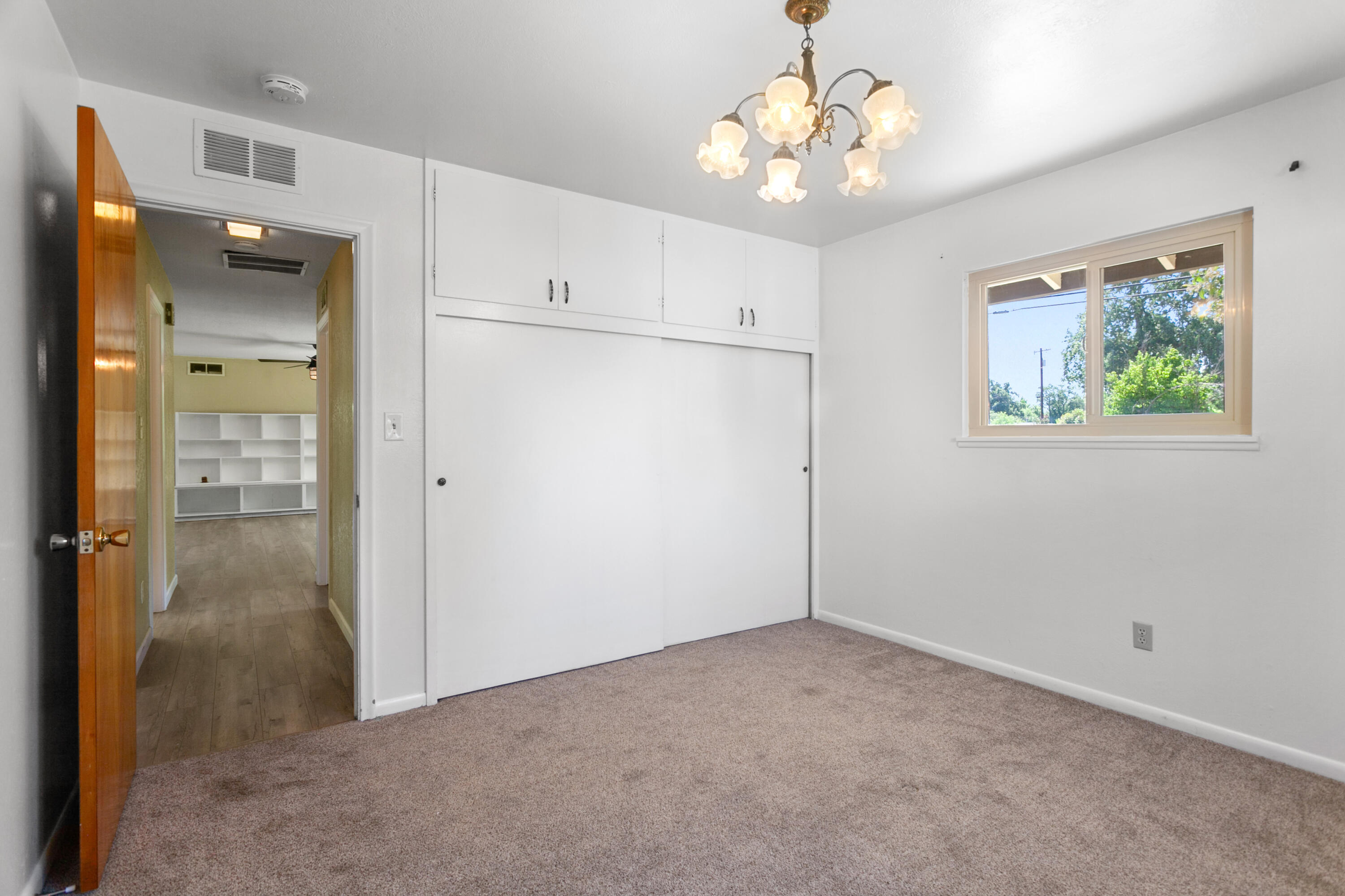 5858 Deschutes Road Anderson, CA 96007 - Photo 6 of 30 wooden floor in an empty room with a window