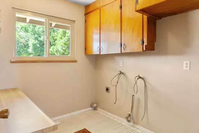 a bathroom with a window and a glass door
