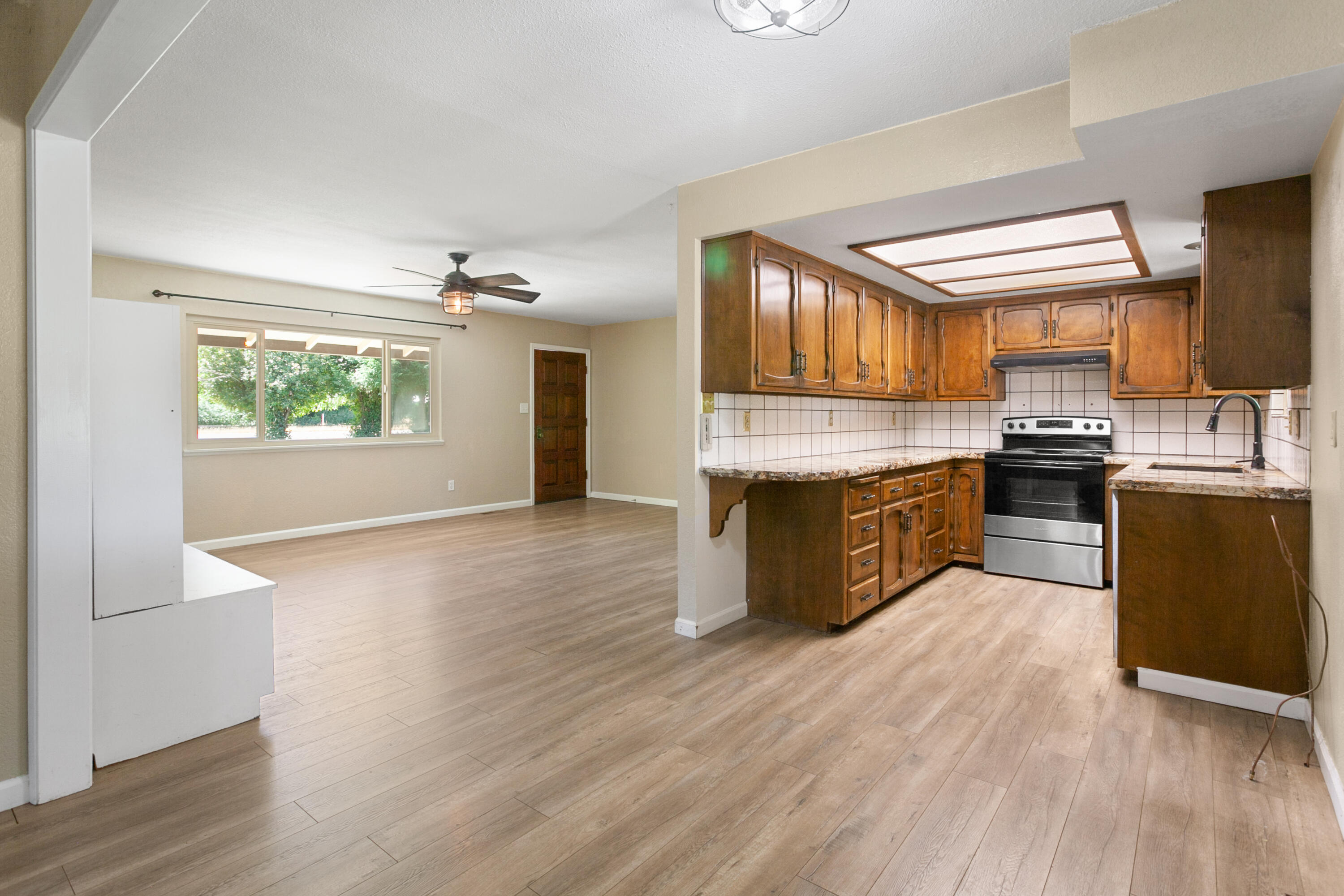 5858 Deschutes Road Anderson, CA 96007 - Photo 10 of 30 a large kitchen with stainless steel appliances granite countertop a stove and a wooden floors
