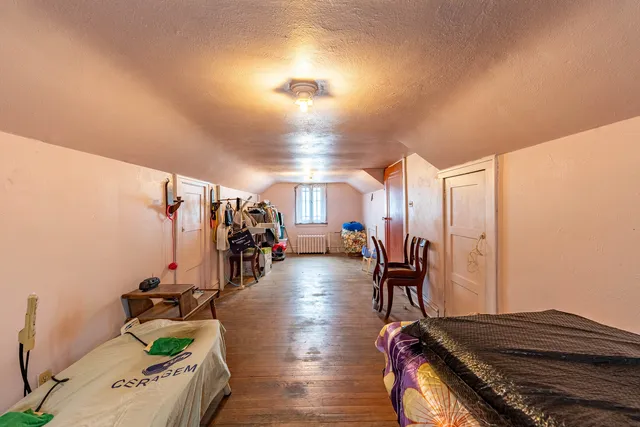 a living room view with couches and dinning table with wooden floor