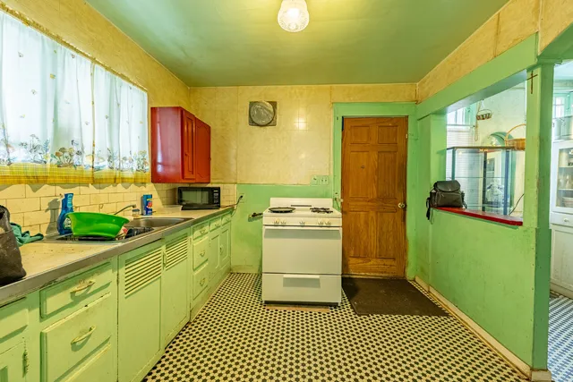 a kitchen with a stove top oven a sink and a microwave