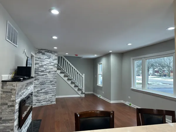 a view of entryway and hall with wooden floor