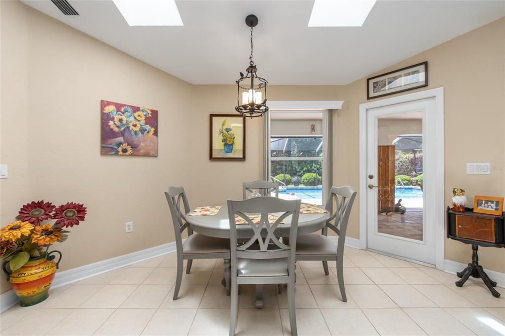 18825 Southwest 93rd Loop Dunnellon, FL 34432 - Photo 26 of 85 a dining room with furniture a chandelier and window