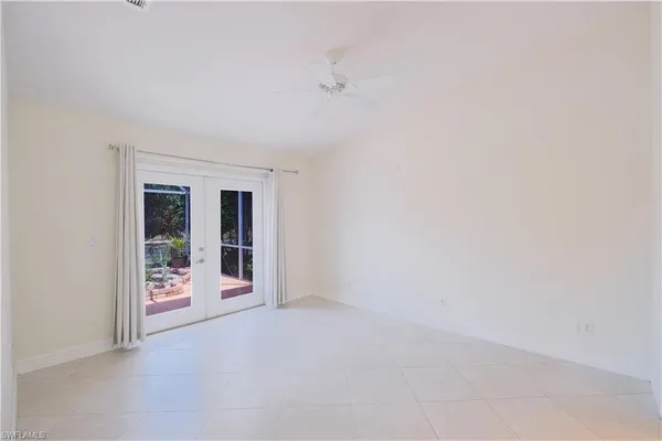 a spacious bathroom with a double vanity sink toilet and a mirror
