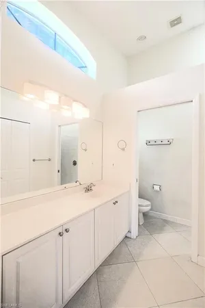 a spacious bathroom with a shower sink and mirror