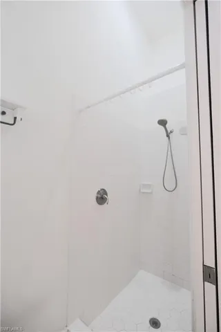 a bathroom with a sink mirror toilet and shower