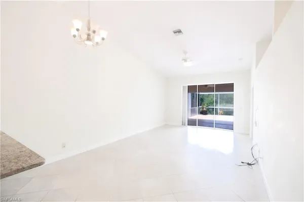 a view of a kitchen with white walls