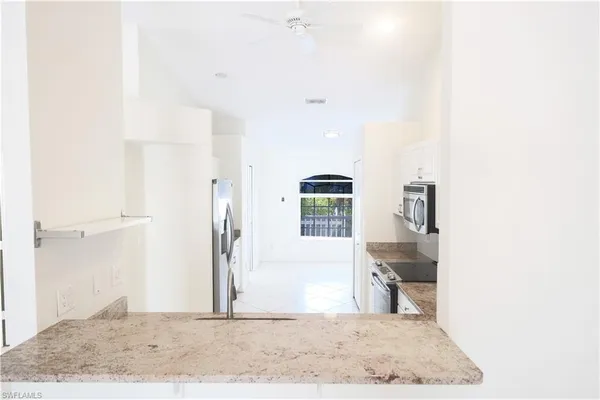 a kitchen with stainless steel appliances a refrigerator sink and stove