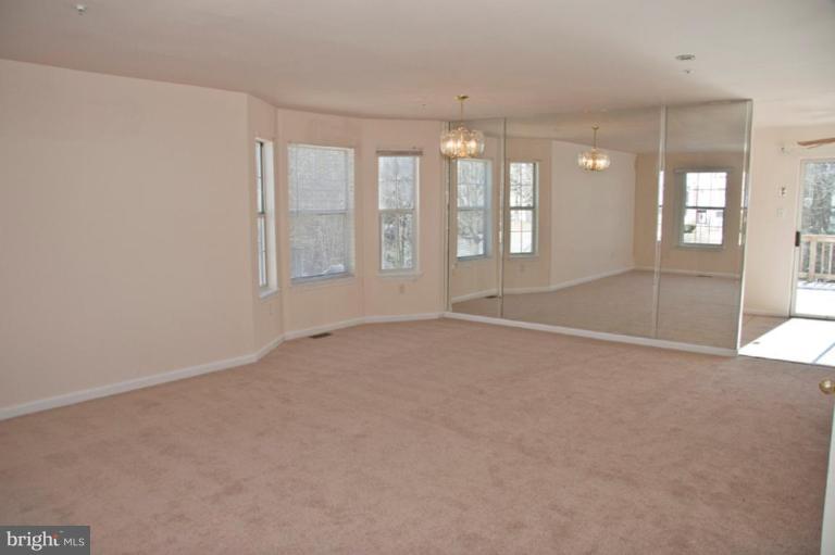 3515 Corn Stream Road Randallstown, MD 21133 - Photo 2 of 23 a view of an empty room with chandelier and a window
