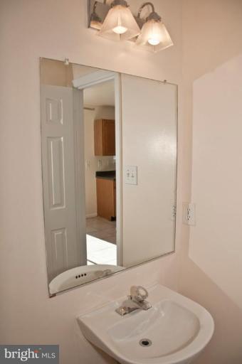 3515 Corn Stream Road Randallstown, MD 21133 - Photo 11 of 23 a bathroom with a sink a mirror and a shower