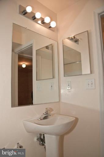 3515 Corn Stream Road Randallstown, MD 21133 - Photo 7 of 23 a bathroom with a sink and a mirror