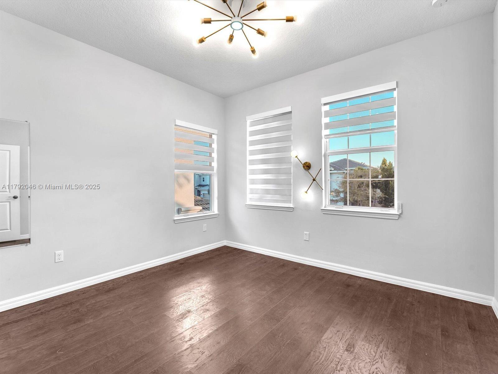 4317 Ficus Street Hollywood, FL 33021 - Photo 19 of 29 a view of wooden floor and windows in a room