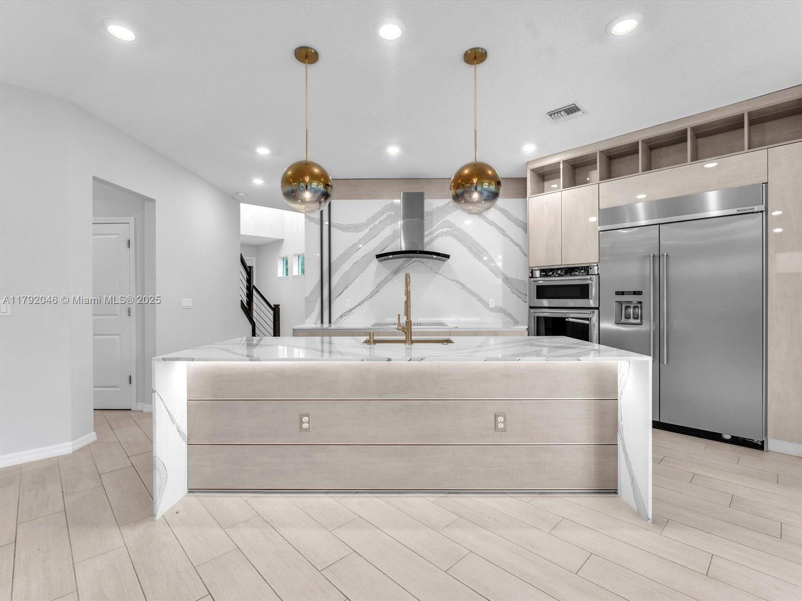 4317 Ficus Street Hollywood, FL 33021 - Photo 2 of 29 a kitchen with kitchen island a counter top space appliances and a ceiling fan