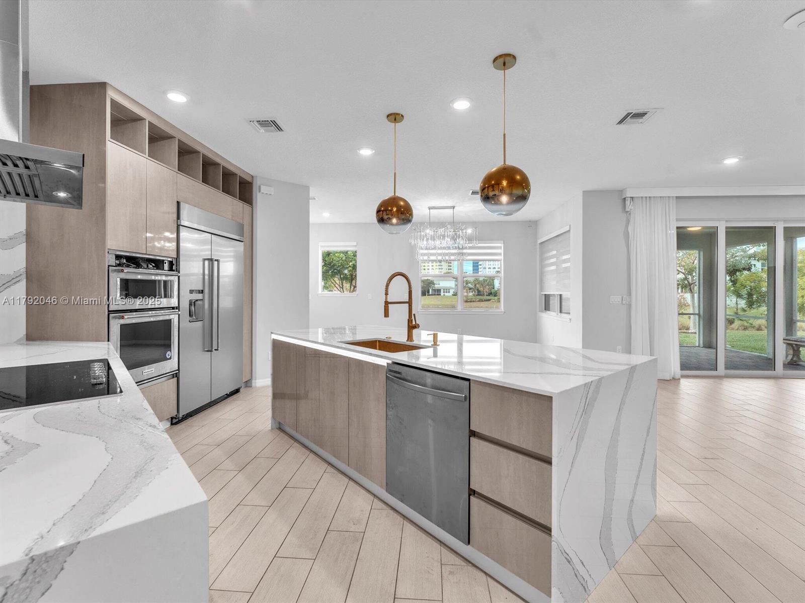 4317 Ficus Street Hollywood, FL 33021 - Photo 3 of 29 a kitchen with stainless steel appliances kitchen island granite countertop a sink and cabinets