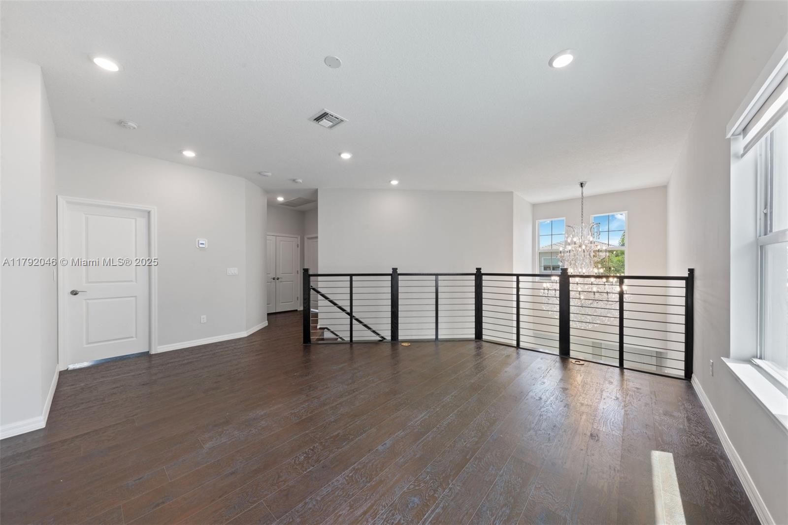 4317 Ficus Street Hollywood, FL 33021 - Photo 10 of 29 a view of an empty room with wooden floor and a window
