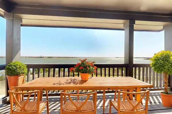 a view of a chairs and table in the balcony