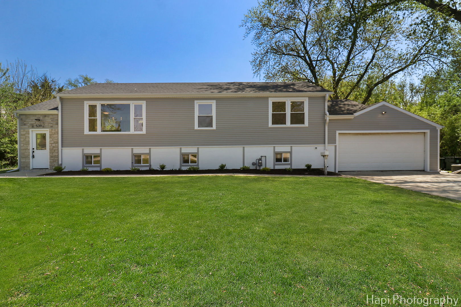 a front view of house with yard and green space