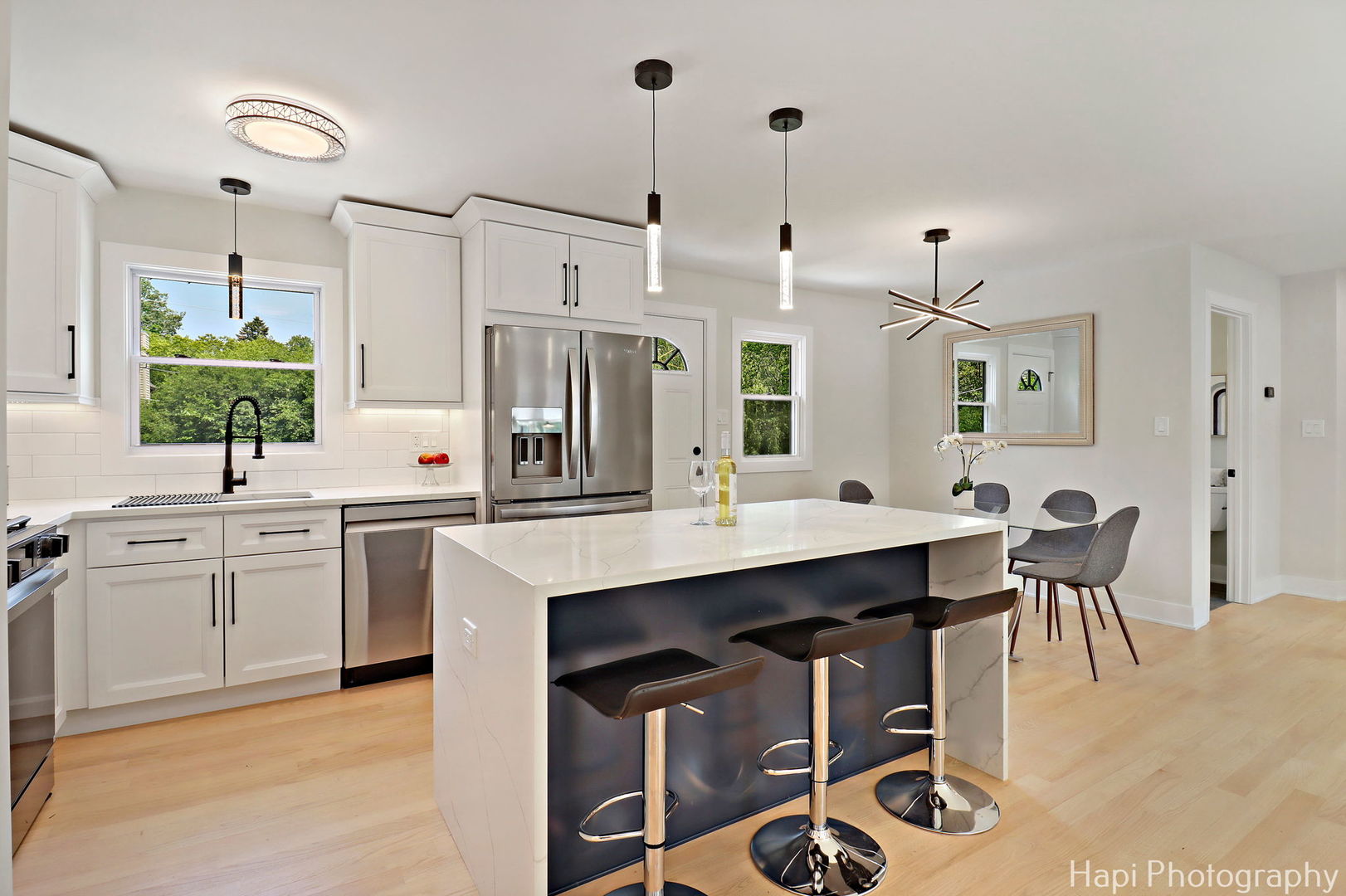 539 South Plum Grove Road Palatine, IL 60067 - Photo 4 of 33 a kitchen with kitchen island a dining table chairs sink and wooden floor