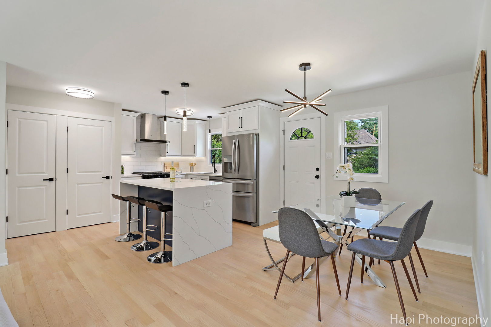 539 South Plum Grove Road Palatine, IL 60067 - Photo 7 of 33 a kitchen with kitchen island a dining table chairs stainless steel appliances and cabinets