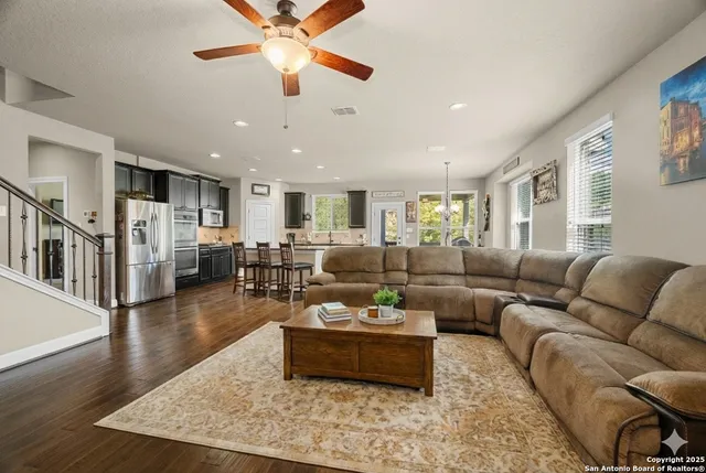 a living room with furniture wooden floor and a table