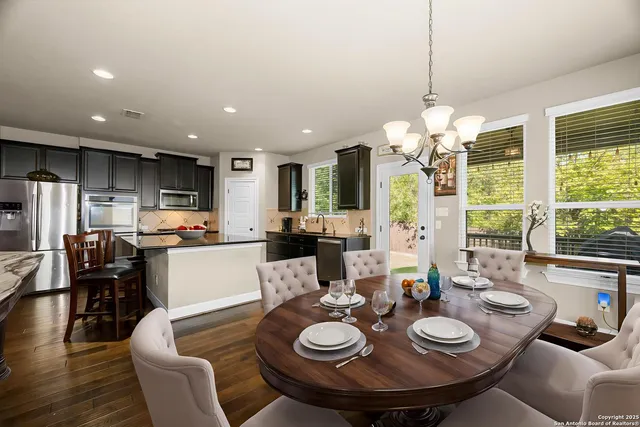 a kitchen with stainless steel appliances granite countertop a sink and a refrigerator