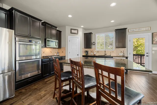 a bedroom with a bed couch and a large window