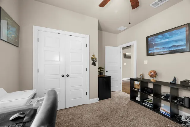 a view of a livingroom with furniture and a mirror
