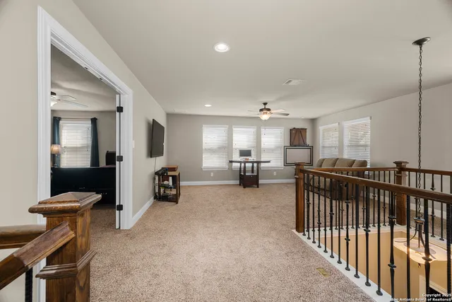 a bedroom with a bed and ceiling fan