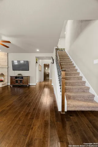 a view of a livingroom with wooden floor and a flat screen tv