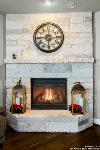 a living room with furniture kitchen view and a fireplace