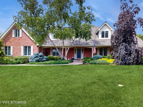a front view of a house with garden and porch