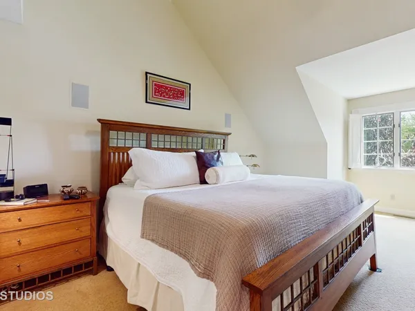 a bedroom with a bed and a window