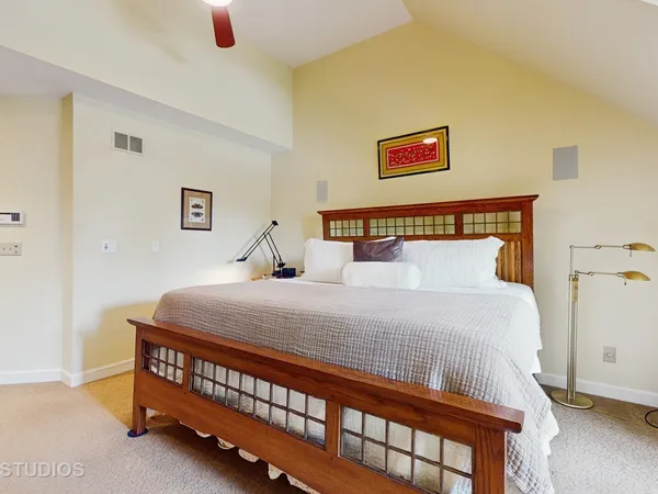 a bedroom with a bed and a baby crib