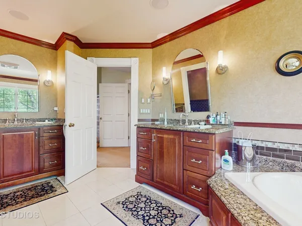 a spacious bathroom with a granite countertop tub and a sink