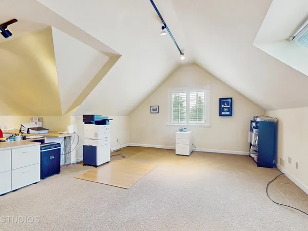 a view of a kitchen with fridge and workspace